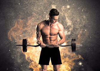Healthy hot male showing muscles with fire