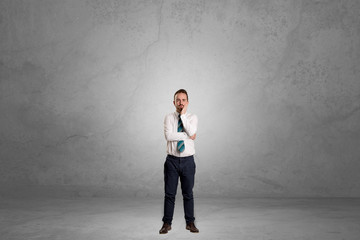 Alone businessman standing in a dark room