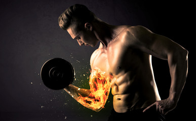 Bodybuilder athlete lifting weight with fire explode arm concept