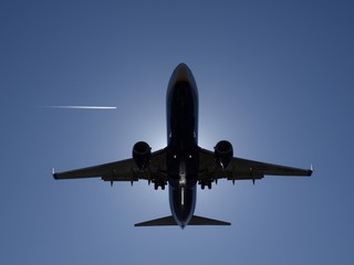 Airplane landing aproach with sun backlight