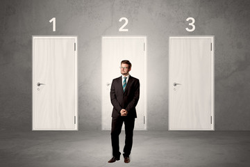Fototapeta premium Businessman thinking in front of three doors