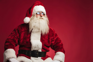 santa claus resting on a chair and looks to side