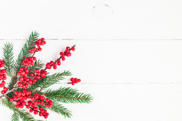 Christmas composition. Fir tree branches and red berries on white background. Christmas, winter,...