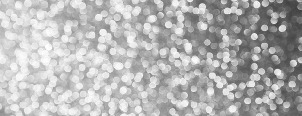 silver and white bokeh lights defocused. abstract background - panoramic