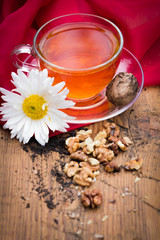 mug of tea with lemon and nuts on a wooden stand. I love autumn. I love tea.