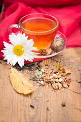 mug of tea with lemon and nuts on a wooden stand. I love autumn. I love tea.