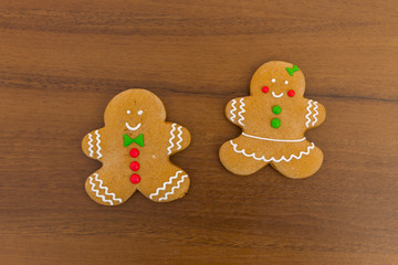 Christmas gingerbread couple cookies on wooden table