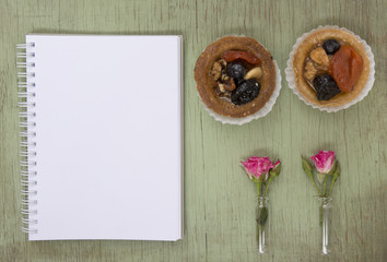 Blank notebook mock up for artwork with pink roses and cake. Place for text. Fresh flower.