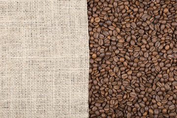 Grains of coffee on which left burlap with copy space