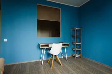 Modern interior of room with armchair on blue wall background