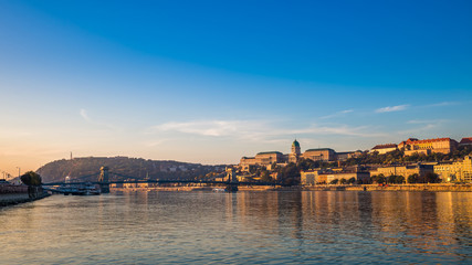 Fototapeta premium Budapest, Hungary - Golden surise over the River Danube with Szechenyi Chain Bridge, Buda Castle Royal Palace, Gellert Hill and Statue of Liberty at background