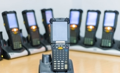 Handheld barcode scanner are charging on table 