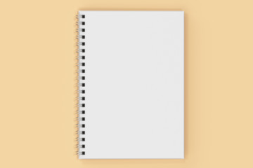 Opend notebook spiral bound on orange background