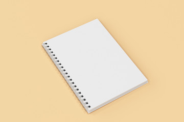 Opend notebook spiral bound on orange background