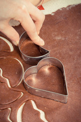 Vintage photo, Using cookie cutters for baking festive cookies or gingerbread, Christmas time concept