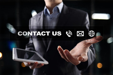 Contact us button and text on virtual screen. Business and technology concept.