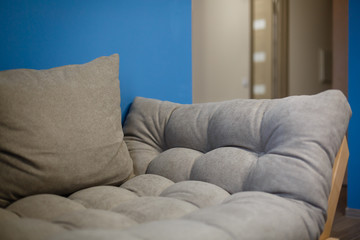 Modern white design sofa against blue wall