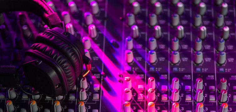 Dj mixer with headphones at a nightclub