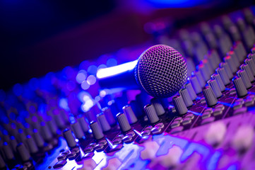 Microphone and Headphones on dirty sound mixer panel