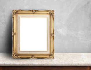 Blank Gold victorian picture frame on white marble table at grey concrete wall,Template mock up for...