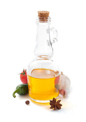 bottle of oil isolated and spices at white