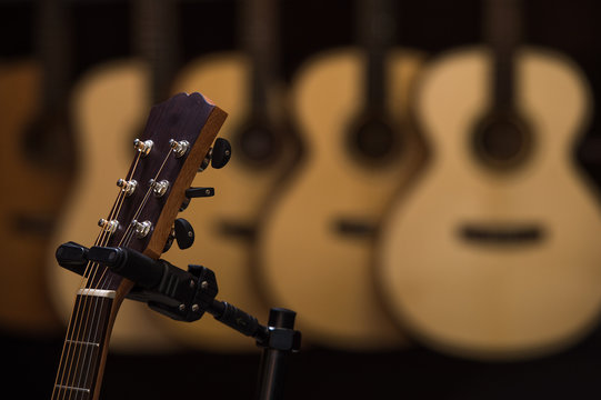 Acoustic classical guitars with strings in shop