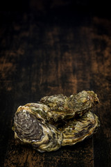 Raw oysters on the wooden table, background