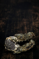 Raw oysters on the wooden table, background