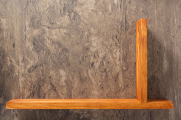 wooden shelf at concrete wall