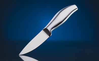 steel kitchen knife on the blue