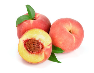 Peaches and half with green leaf isolated on white background