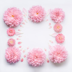 Frame of pink pale flowers with petals on white desktop background, flat lay, top view. Creative floral layout or mock up for greeting card for Mothers day, wedding , happy event or birthday