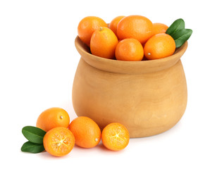 Cumquat or kumquat with leaf in wooden bowl isolated on white background close up