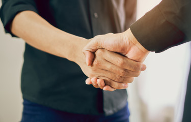 Fototapeta premium Joint Hands of Two Businessmen After Negotiating a Successful Business Agreement, And the handshake together. This is to promote cooperation in the joint business. Teamwork planning