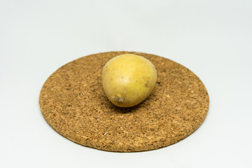 Fototapeta premium single patato isolated on cork with white background