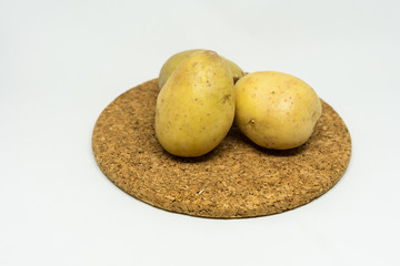 Fototapeta premium two patato isolated on cork with white background