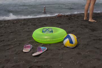 Ball and yellow Floating Ring on beach. Travel or sea vacations concept