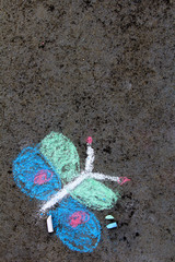 Fototapeta premium Colorful chalk drawing on asphalt: beautiful butterfly