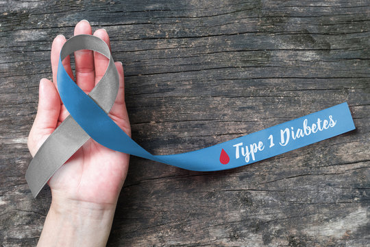 World diabetes day with grey Blue ribbon awareness with red blood drop for diabetic disease type 1 campaign, symbolic bow color  isolated with clipping path on helping hand support