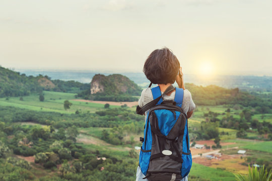 asian traveler woman photographing landscape view on top mountain