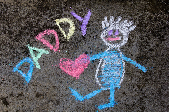 chalk drawing on asphalt: Cute father portrait and word DADDY