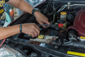 Checking a car battery for repair at car garage