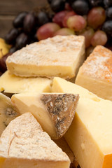 Moldy cheese blocks and grapes