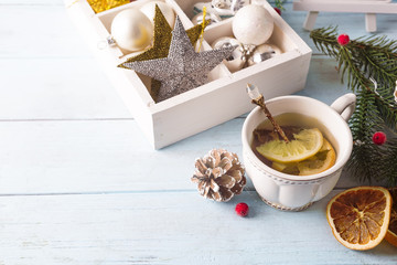 Hot green tea with lemon on a wooden table