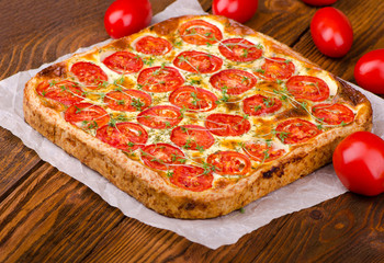 Pie with tomato and fresh herbs, close up. Healthy food, vegetable tart.