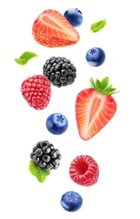 Wall murals Fruits Isolated fresh berries in the air. Falling blackberry, raspberry, blueberry, strawberry fruits and mint leaves isolated on white background with clipping path