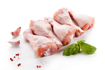 Raw chicken legs on white background
