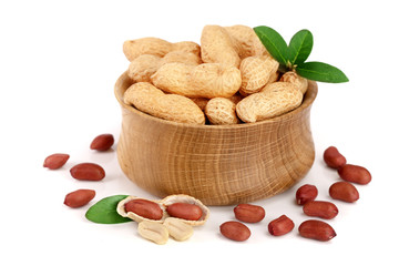peanuts with leaf in wooden bowl isolated on white background