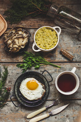 delicious egg on a black background and other products on a wooden surface