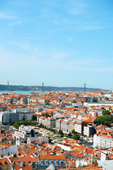 Fototapeta premium Alfama downtown and the 25 April Bridge in Lisbon, Portugal.